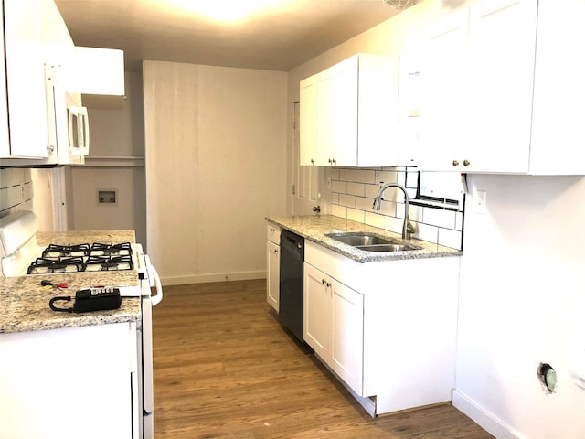 kitchen featuring white appliances, light stone countertops, sink, and white cabinets