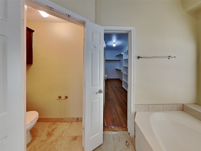 10805 Winged Foot Dr, Rowlett, TX 75089 - bathroom featuring tile patterned flooring, a bathtub, and toilet