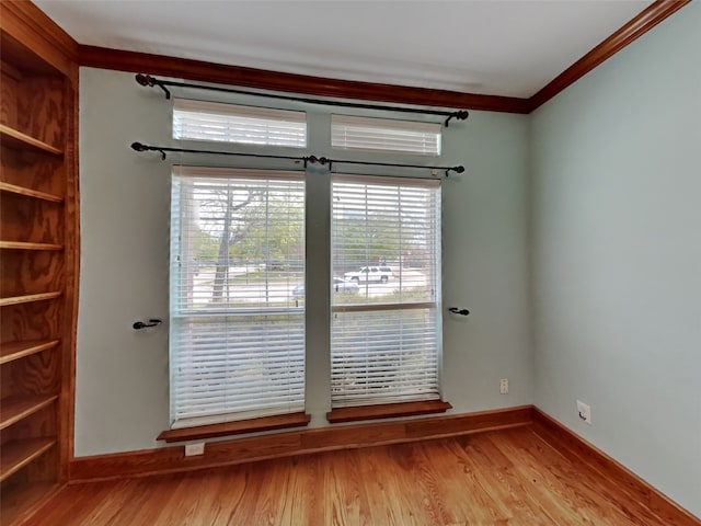 10805 Winged Foot Dr, Rowlett, TX 75089 - unfurnished room with crown molding and light hardwood / wood-style floors