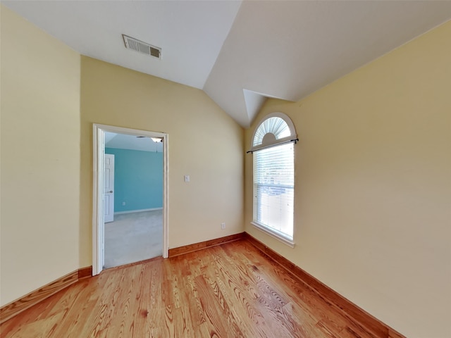 10805 Winged Foot Dr, Rowlett, TX 75089 - spare room featuring vaulted ceiling and light hardwood / wood-style flooring