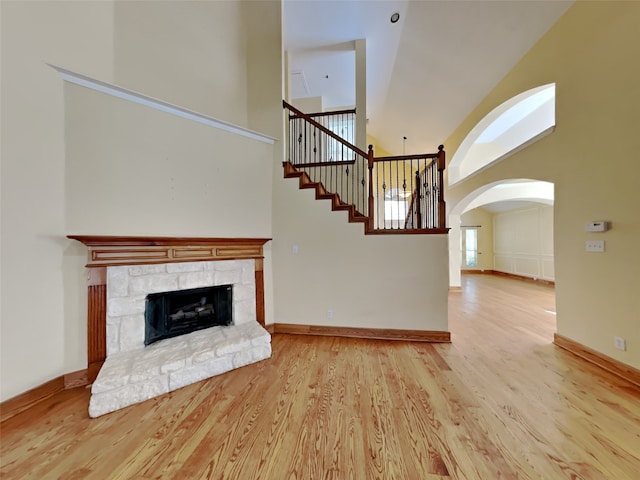 10805 Winged Foot Dr, Rowlett, TX 75089 - unfurnished living room featuring high vaulted ceiling, a fireplace, and light hardwood / wood-style flooring