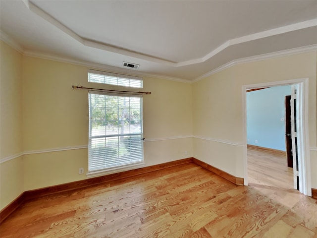 10805 Winged Foot Dr, Rowlett, TX 75089 - unfurnished room with a tray ceiling, crown molding, and light wood-type flooring