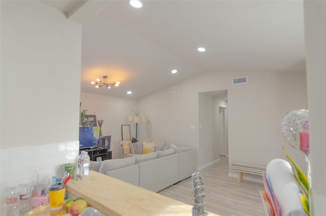 living room featuring vaulted ceiling and light wood-type flooring