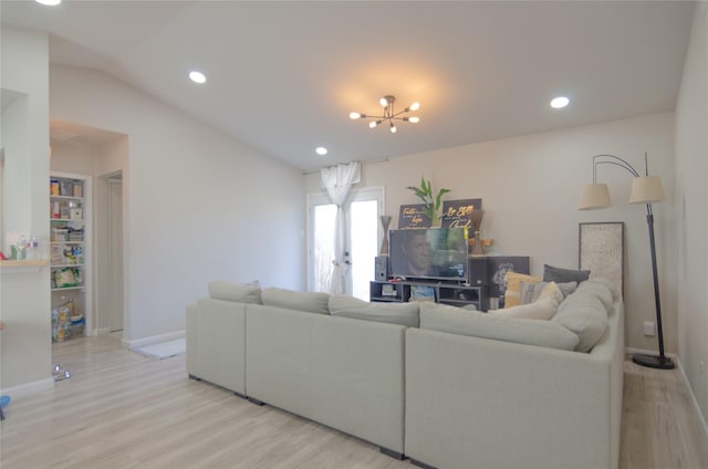 living room with lofted ceiling, a chandelier, and light wood-type flooring