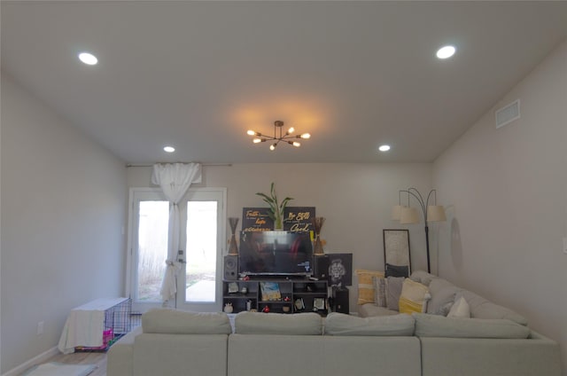 living room featuring hardwood / wood-style flooring and a chandelier