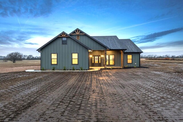 view of back house at dusk