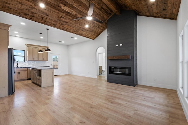 kitchen with black fridge, wood ceiling, decorative light fixtures, a kitchen island, and a fireplace