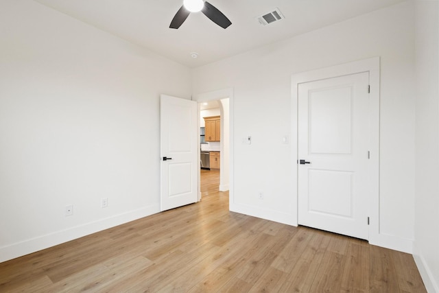 unfurnished bedroom with ceiling fan and light hardwood / wood-style floors