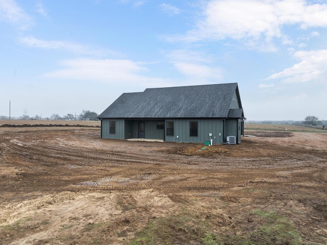 exterior space featuring cooling unit and a rural view