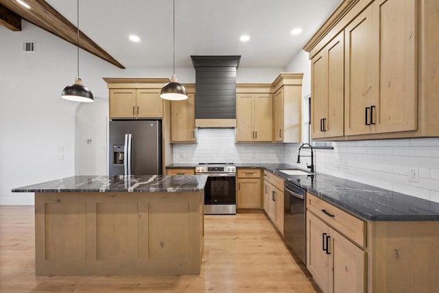 kitchen featuring stainless steel appliances, a kitchen island, sink, and hanging light fixtures