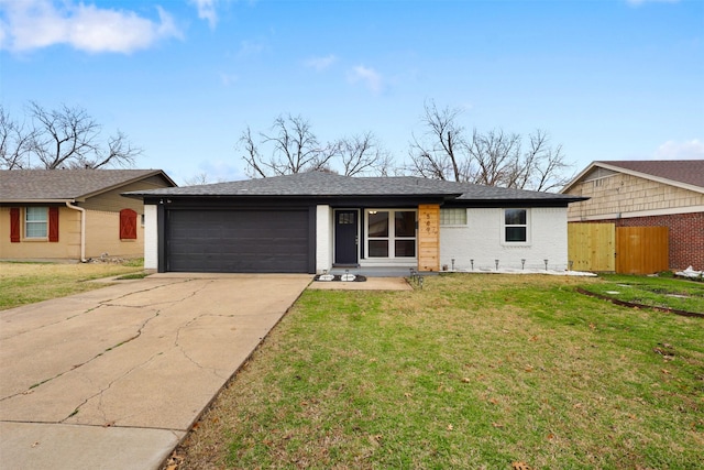 ranch-style home with a garage and a front lawn