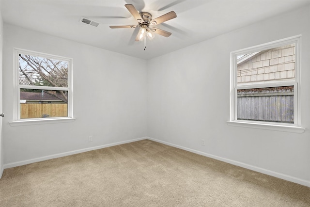 empty room with ceiling fan and carpet