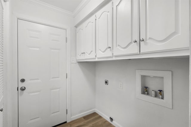 clothes washing area featuring hardwood / wood-style floors, cabinets, hookup for a washing machine, crown molding, and hookup for an electric dryer