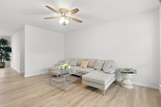 living room featuring ceiling fan and light wood-type flooring