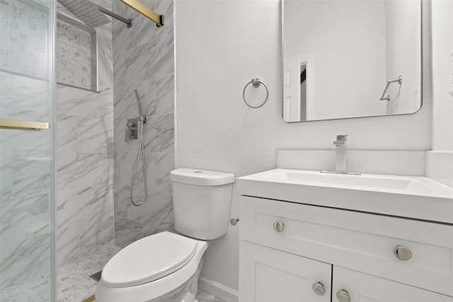 bathroom featuring vanity, a shower with shower door, and toilet