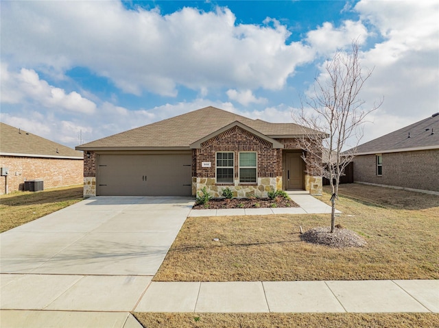 view of front of property with a garage, central air condition unit, and a front lawn