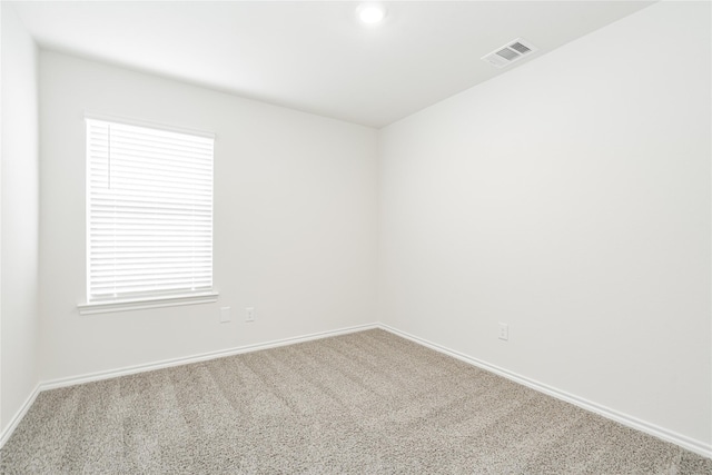 spare room with light colored carpet