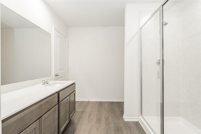 bathroom featuring an enclosed shower, vanity, and hardwood / wood-style flooring