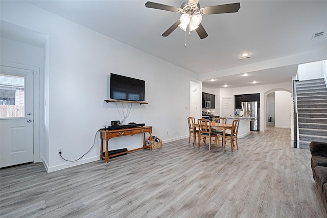 living room featuring ceiling fan and light wood-type flooring