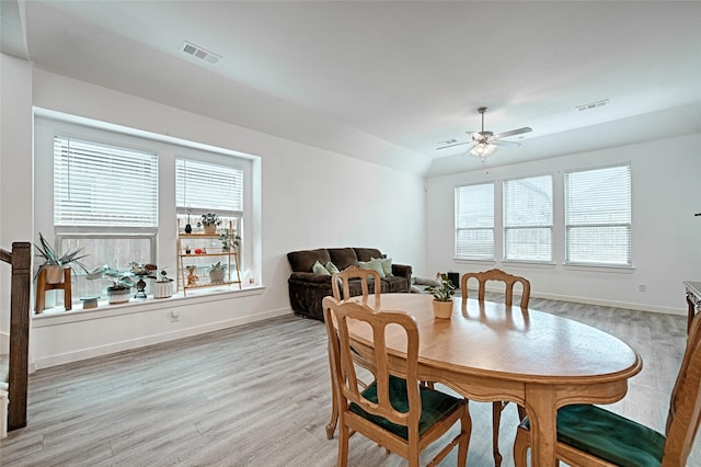 dining space featuring vaulted ceiling, light hardwood / wood-style floors, and ceiling fan