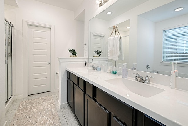 bathroom featuring vanity, tile patterned floors, and walk in shower