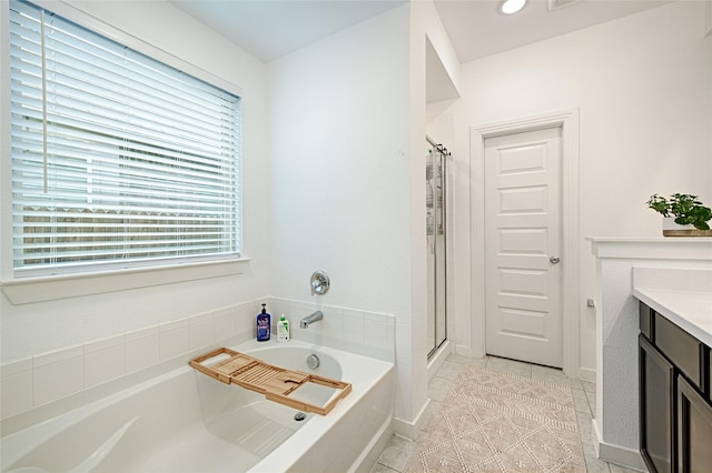 bathroom featuring tile patterned floors, plus walk in shower, and vanity