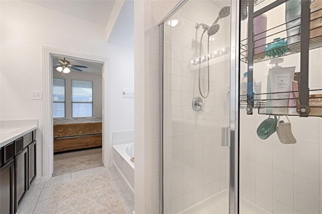 bathroom with tile patterned floors, shower with separate bathtub, and vanity