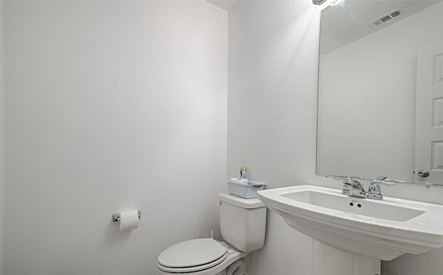 bathroom with toilet and sink