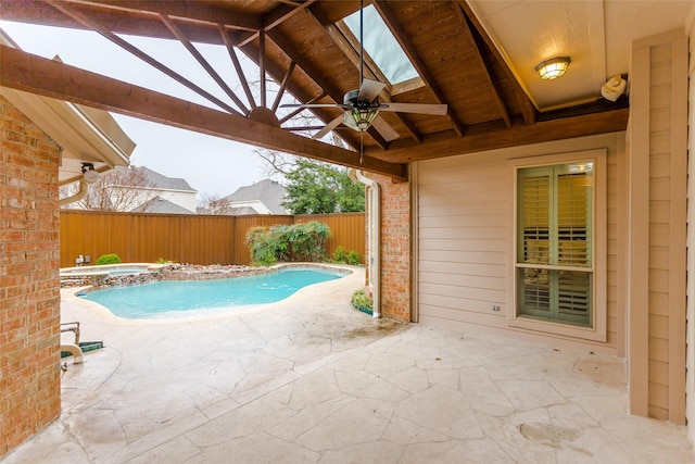 view of pool featuring an in ground hot tub, a patio area, a fenced backyard, and a ceiling fan