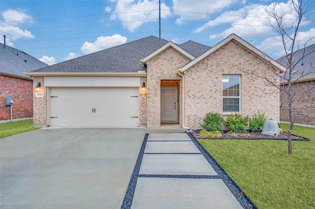 view of front of house with a garage and a front lawn