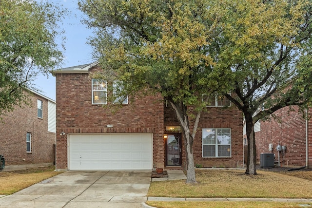 view of front of home with a garage, central AC unit, and a front lawn