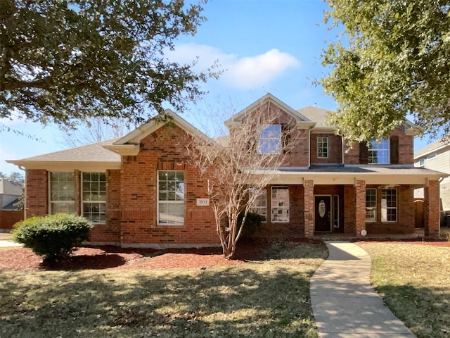 view of front of property with a porch and a front lawn