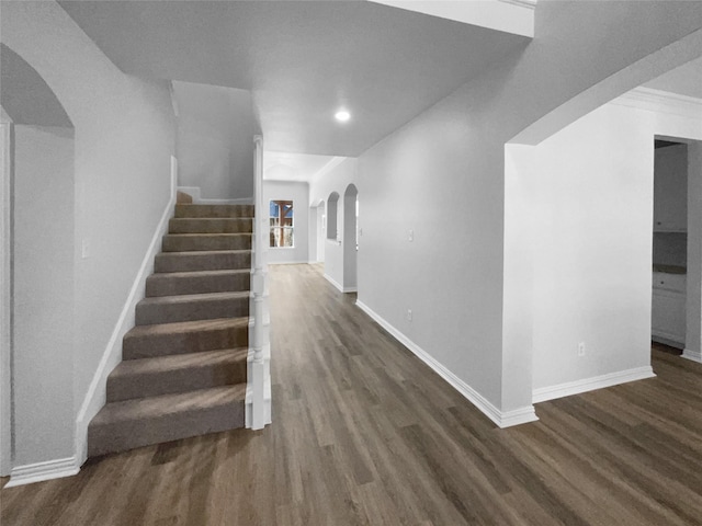 stairs featuring hardwood / wood-style floors