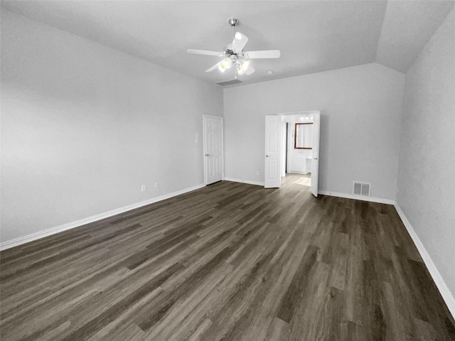 empty room featuring vaulted ceiling, dark hardwood / wood-style floors, and ceiling fan