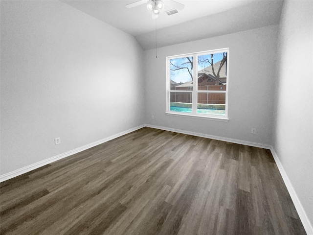 unfurnished room with dark hardwood / wood-style flooring, vaulted ceiling, and ceiling fan