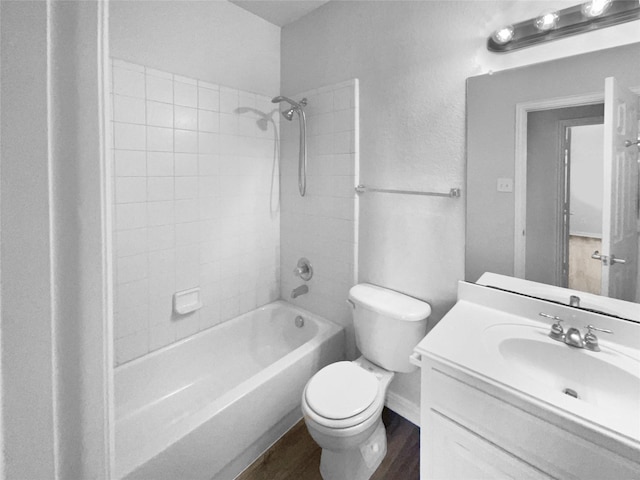 full bathroom with vanity, toilet, tiled shower / bath combo, and wood-type flooring