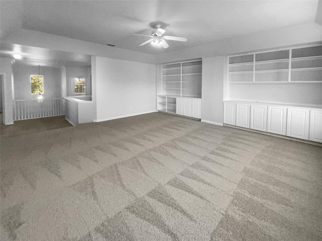 unfurnished living room with carpet flooring and ceiling fan