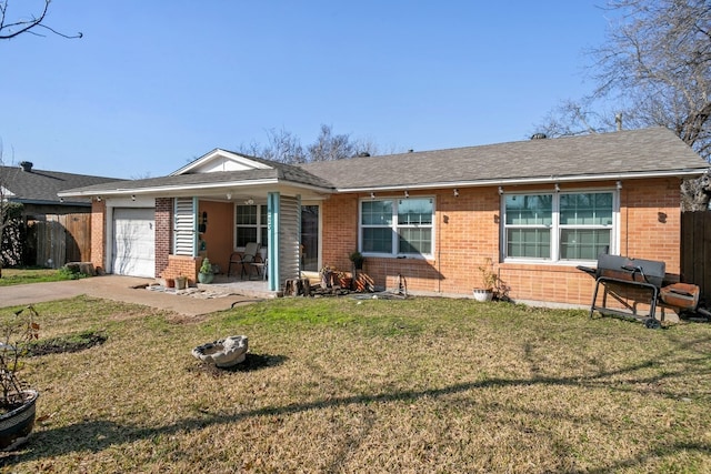 ranch-style house featuring a garage and a front yard