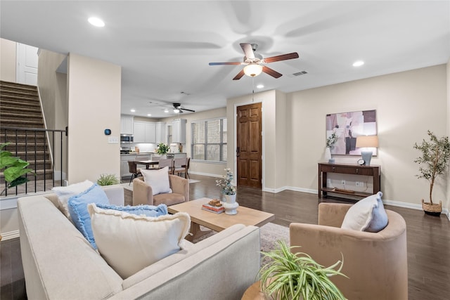 living room with dark hardwood / wood-style floors and ceiling fan