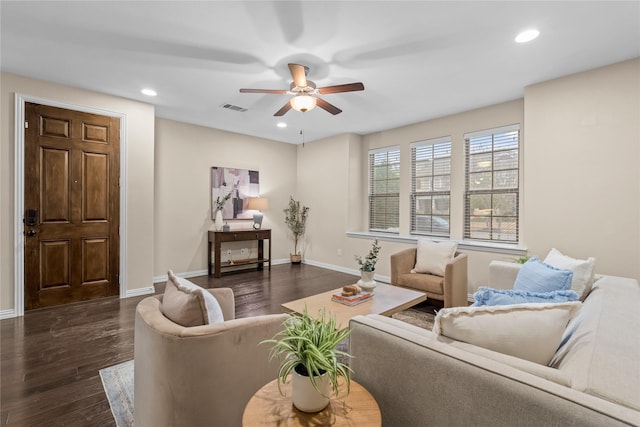 living room featuring ceiling fan and dark hardwood / wood-style flooring