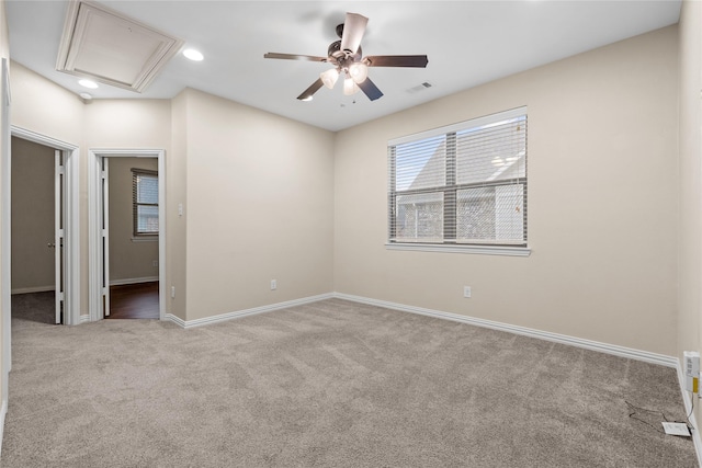 carpeted spare room with ceiling fan