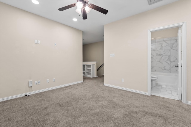 spare room with light colored carpet and ceiling fan