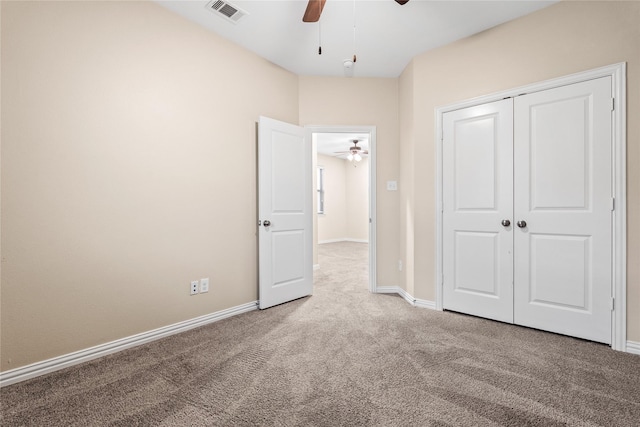 unfurnished bedroom featuring carpet flooring, ceiling fan, and a closet