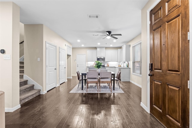 dining space featuring dark hardwood / wood-style floors and ceiling fan