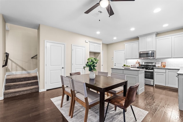 dining space with dark hardwood / wood-style floors and ceiling fan