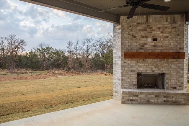 view of patio featuring ceiling fan and an outdoor brick fireplace