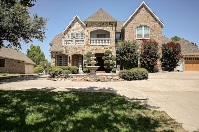 view of front of house with a garage and a balcony