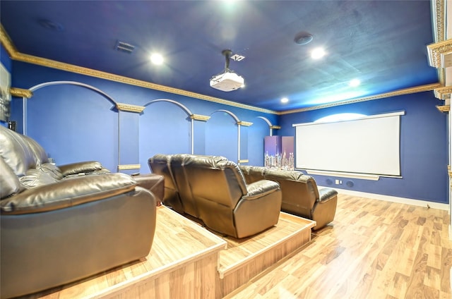 home theater with crown molding and wood-type flooring