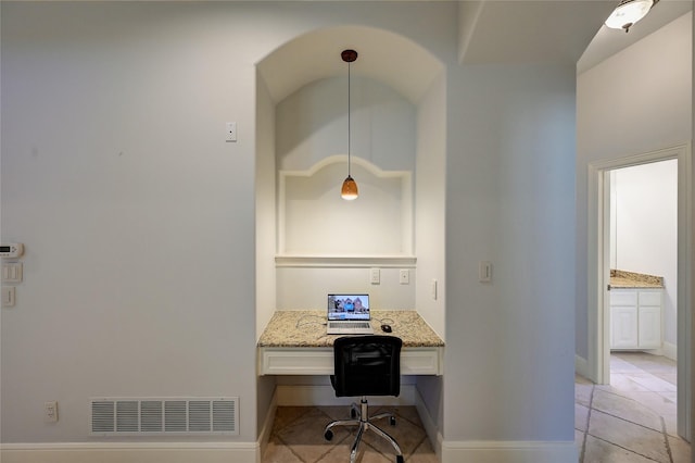 office area featuring built in desk and light tile patterned floors