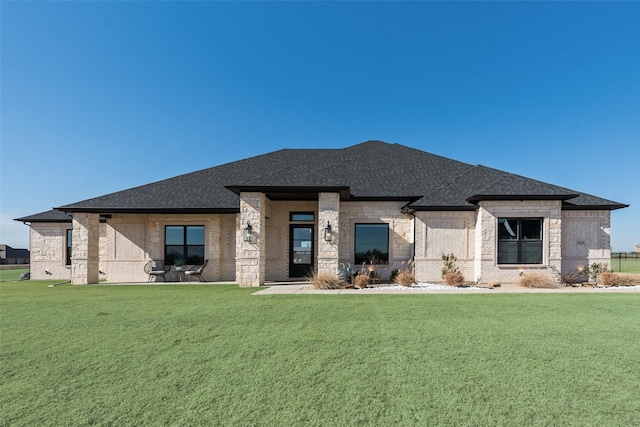 rear view of house featuring a yard